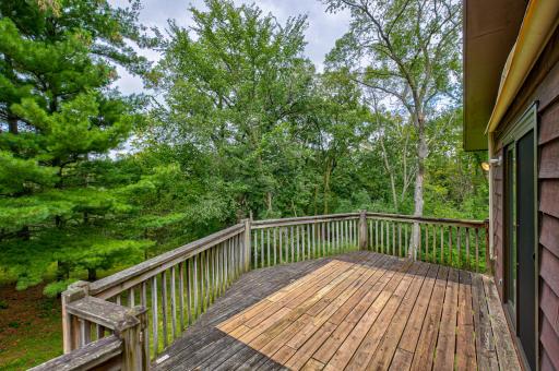 Step out to your private deck and enjoy gatherings with views of the spacious wooded backyard