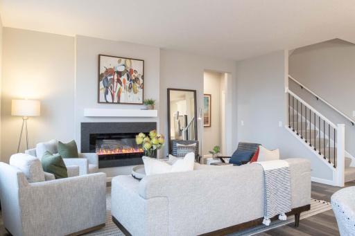 This home features a stunning open-concept design that seamlessly connects the family room, kitchen, and dining area, creating an ideal space for both daily living and entertaining. Photos are from previously built home; options and features may vary