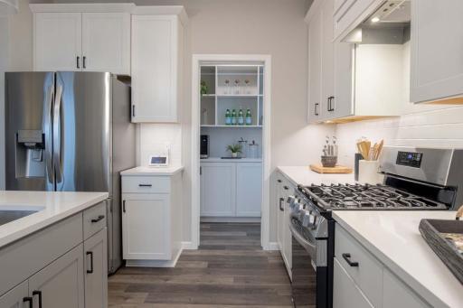 Step right into the morning kitchen, a thoughtfully designed pantry that combines organization & functionality. Photos are from previously built home; options and features may vary.