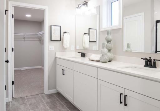 The double sink vanity in the primary bath offers both convenience and style, making it the perfect feature for busy mornings or shared spaces. Photos are from previously built home; options and features may vary.