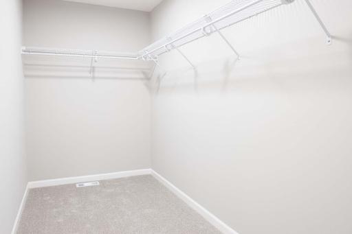 The spacious walk-in closet offers an abundance of storage and organization, making it the perfect space for your wardrobe. Photos are from previously built home; options and features may vary.