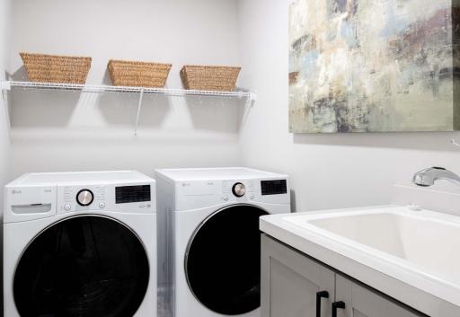 Conveniently located upstairs, this spacious laundry room offers both practicality and ease. Featuring a built-in laundry sink, it provides an ideal spot for washing delicates. Photos are from previously built home; options and features may vary.