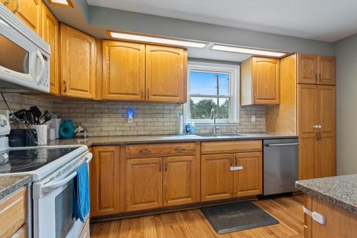 Overhead lighting illuminates the granite countertops - you'll enjoy spending your time preparing meals in this kitchen!