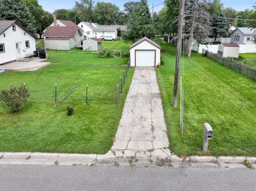 Concrete driveway leads to the detached garage for everyday convenience