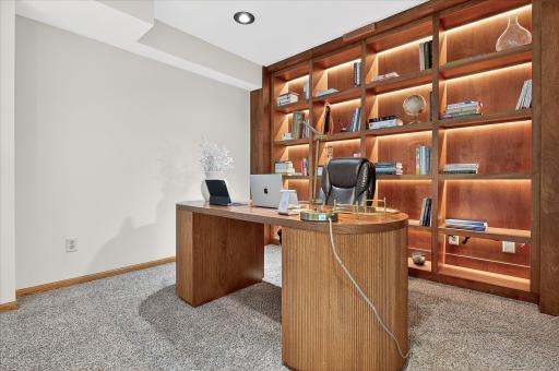 Talk about an office!! The sellers recently installed this amazing shelving system and desk. This is in the lower level too.