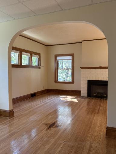 Living room with fireplace and lovely piano window