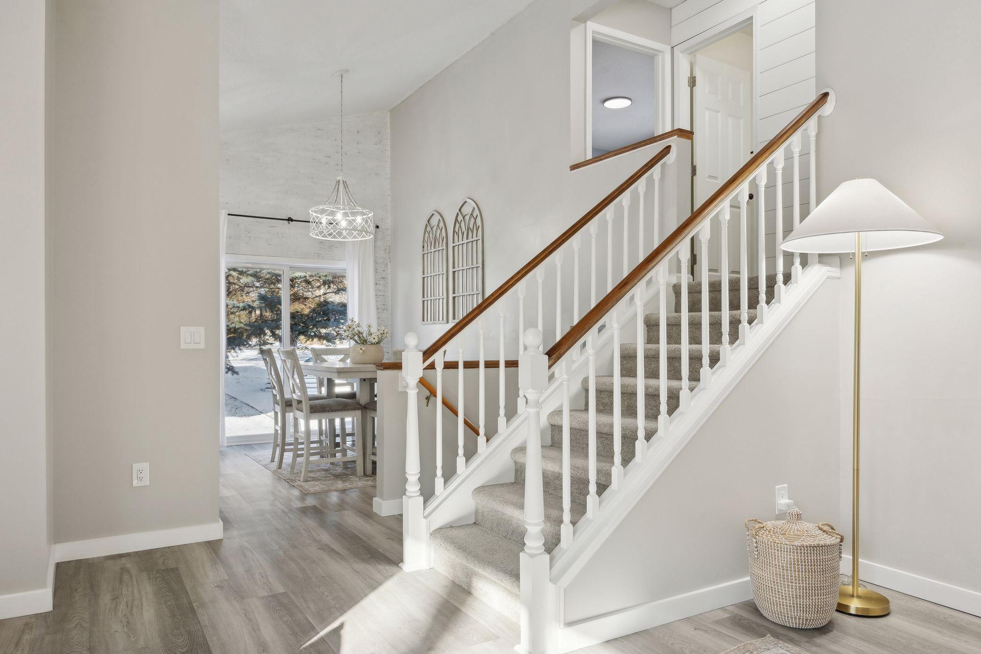 16x12 Main Level Kitchen updated with refaced white cabinetry in 2020, New dishwasher in 2024, new quartz countertops and backsplash, Fresh paint, new flooring, and white trim. North-facing windows and a sliding glass door to the side yard.