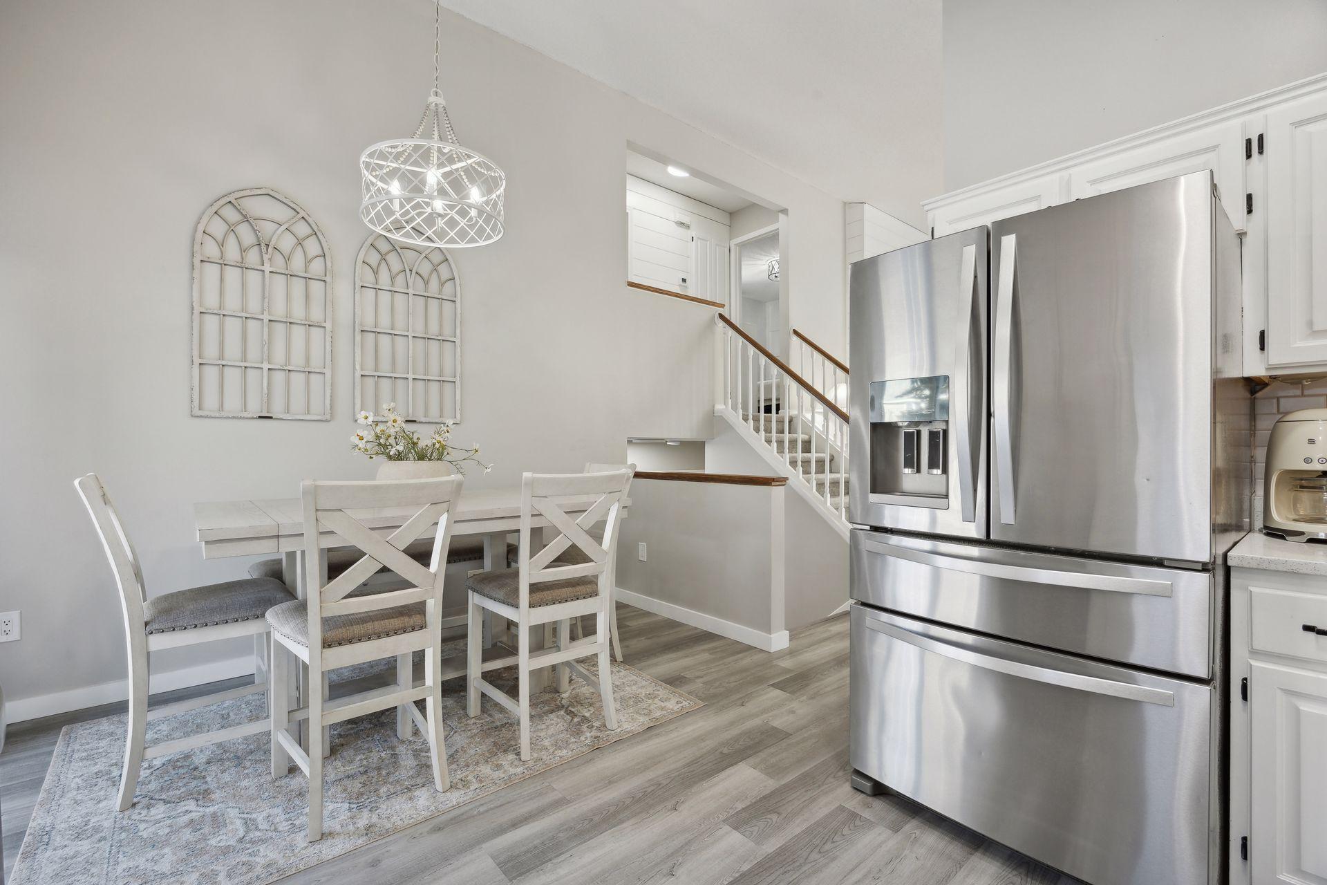 16x12 Main Level Kitchen updated with refaced white cabinetry in 2020, New dishwasher in 2024, new quartz countertops and backsplash, Fresh paint, new flooring, and white trim. North-facing windows and a sliding glass door to the side yard.
