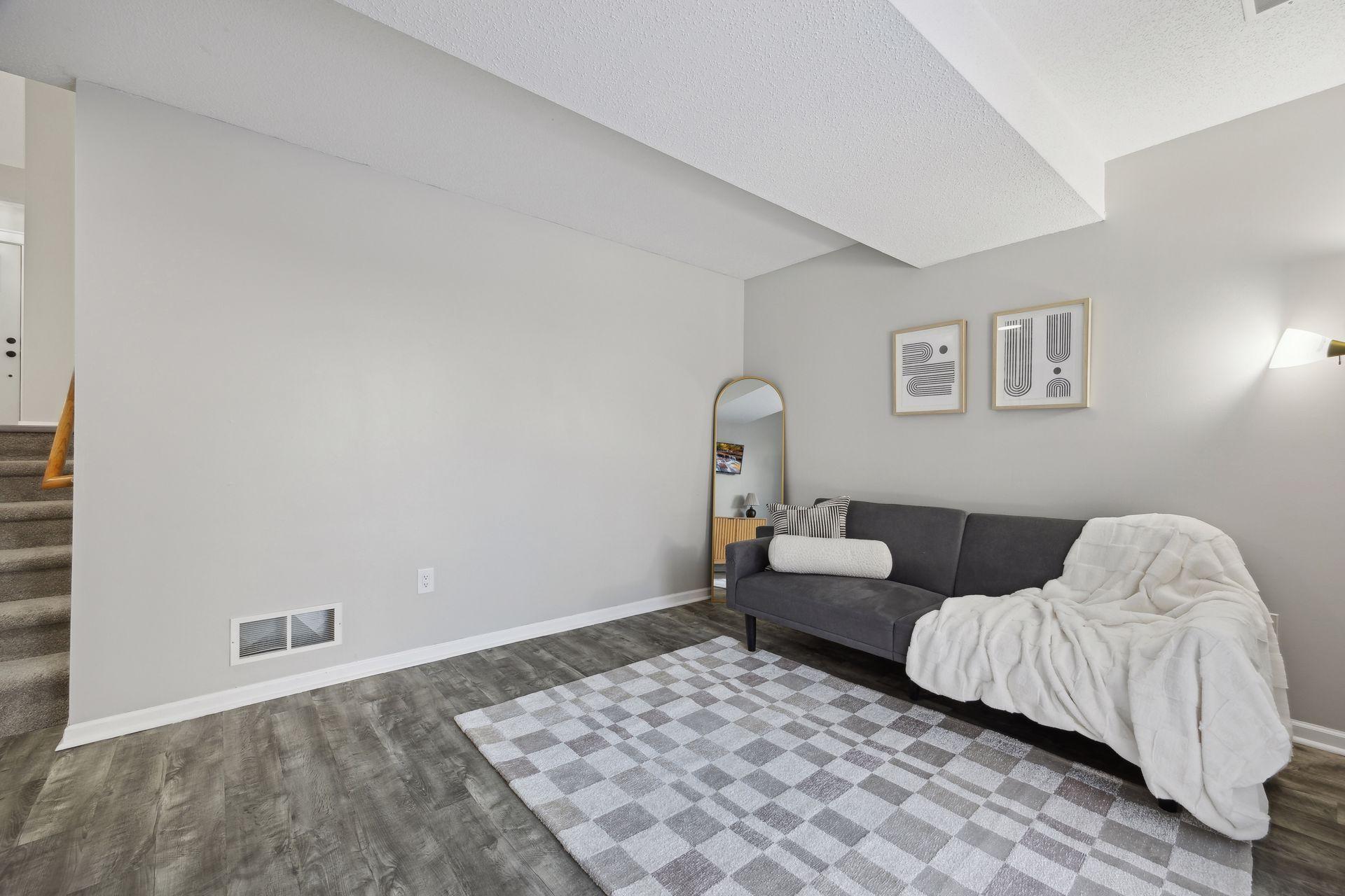 17x11 lower-level family room with East-facing sliding glass doors to back yard, updated flooring, fresh paint and white trim.