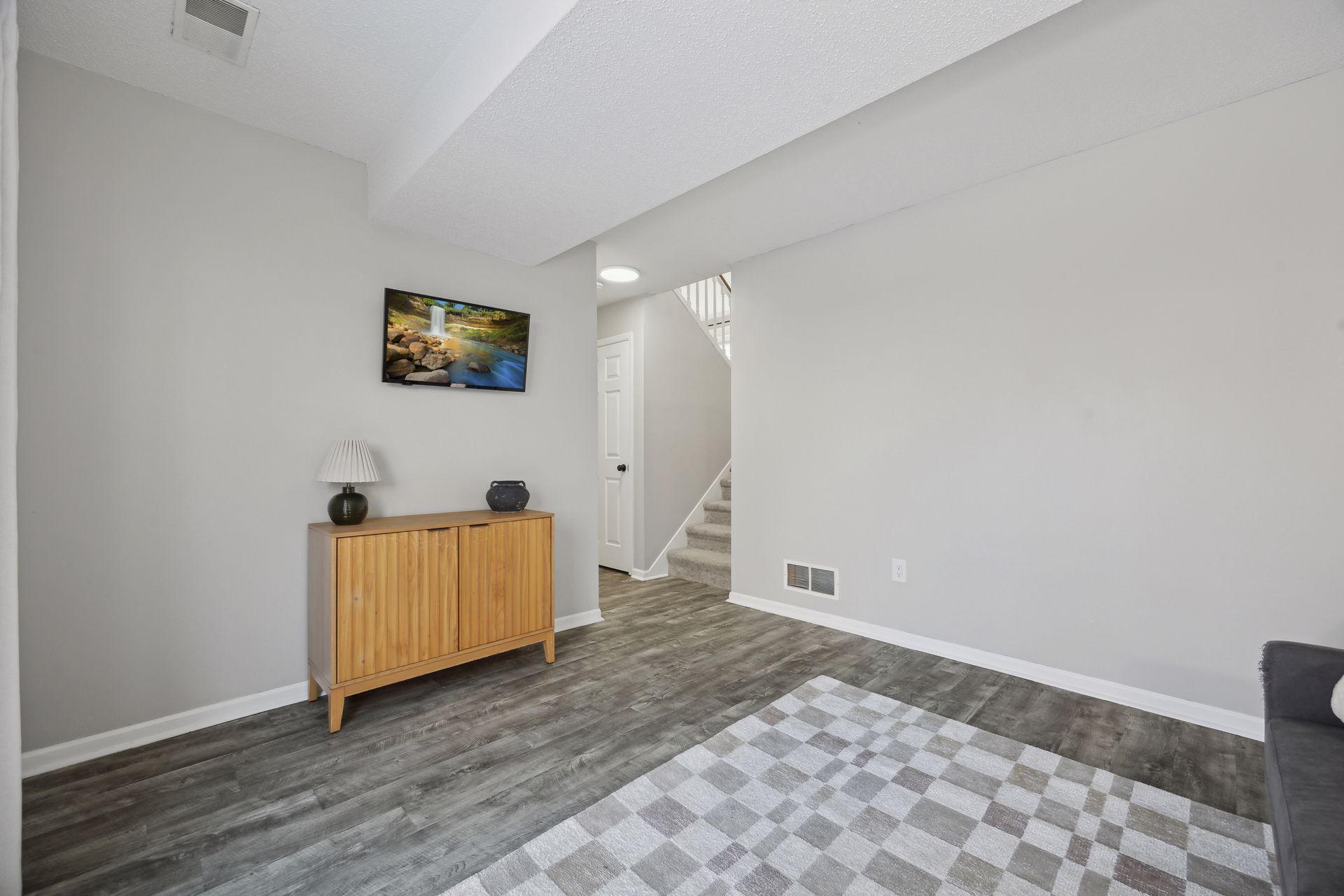 17x11 lower-level family room with East-facing sliding glass doors to back yard, updated flooring, fresh paint and white trim.