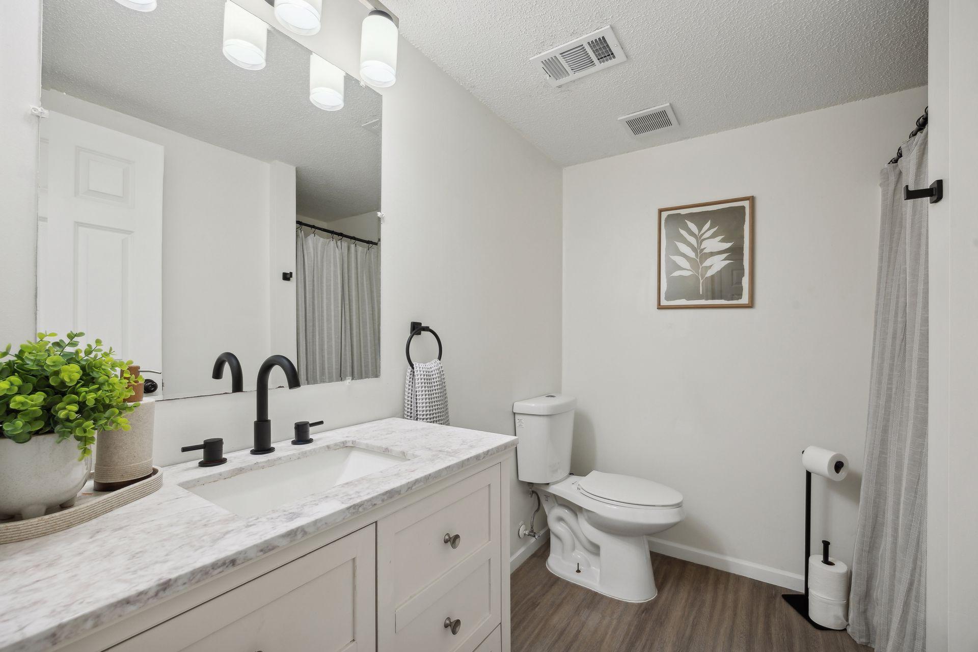 Lower Level 3/4 bath with updated styling, Mable top shaker style vanity, new faucet, and fresh paint.
