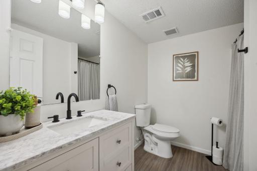 Lower Level 3/4 bath with updated styling, Mable top shaker style vanity, new faucet, and fresh paint.