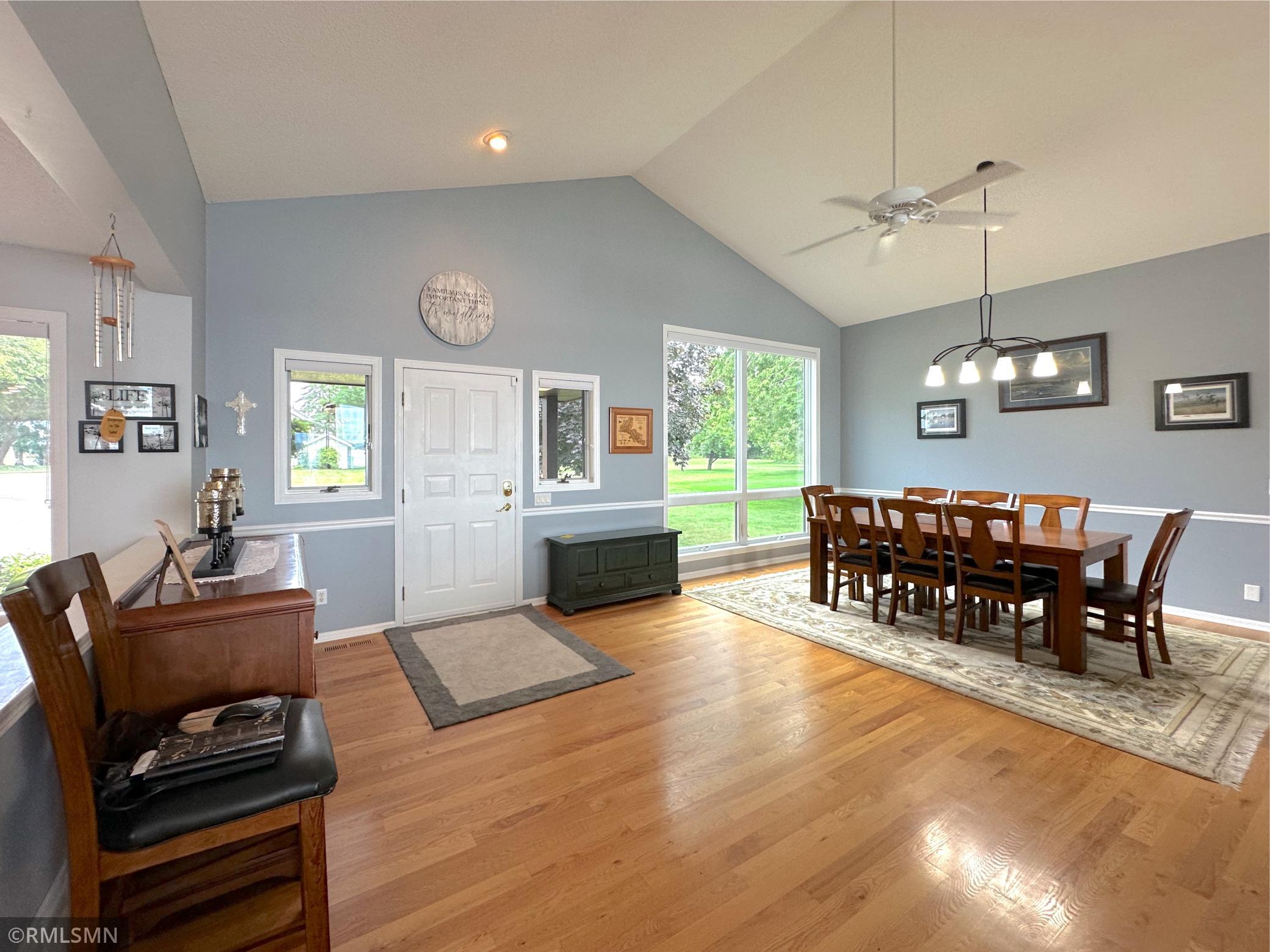 Step inside to a welcoming foyer that opens seamlessly into the dining room with soaring vaulted ceilings.