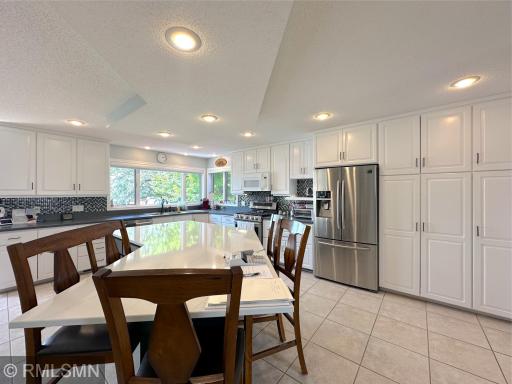Expansive windows flood the kitchen with natural light while offering serene shoreline views of the outdoors.