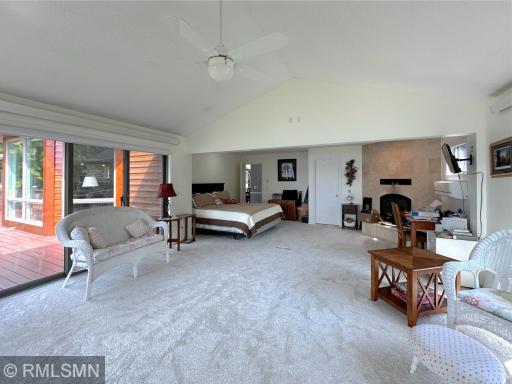 A cozy fireplace adds warmth and charm, while sliding doors open to the spacious lakeside wrap-around deck.