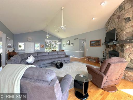 Gather in the spacious living room, where vaulted ceilings and oversized windows fill the space with natural light.