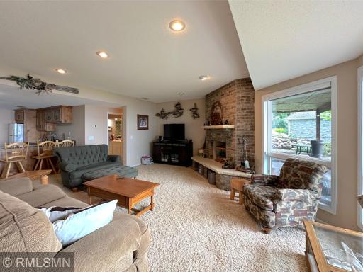 Expansive lower-level family room filled with natural light and stunning lake views through a wall of windows.