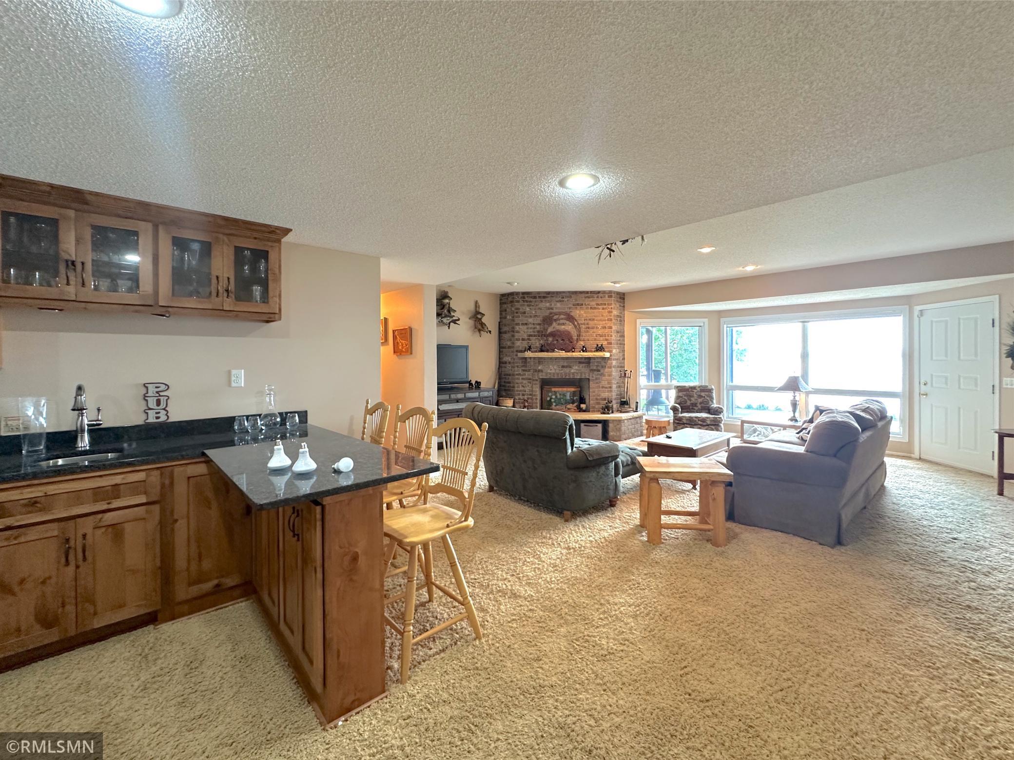 Lower level is made for entertaining with the wet bar opening seamlessly to the spacious lakeside family room.