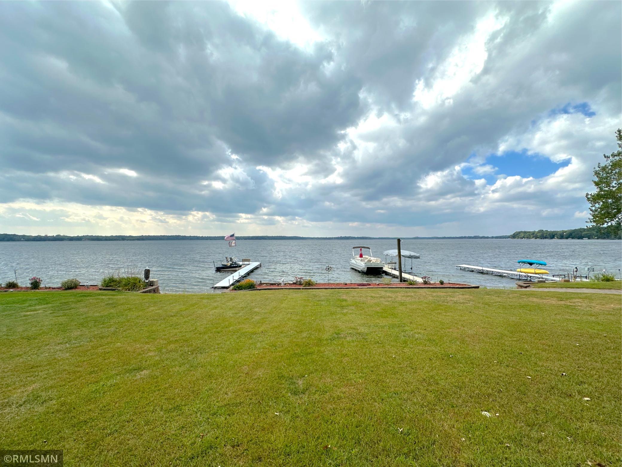 An expansive sandy beach and open yard leading to the shoreline, this property blends comfort and recreation.