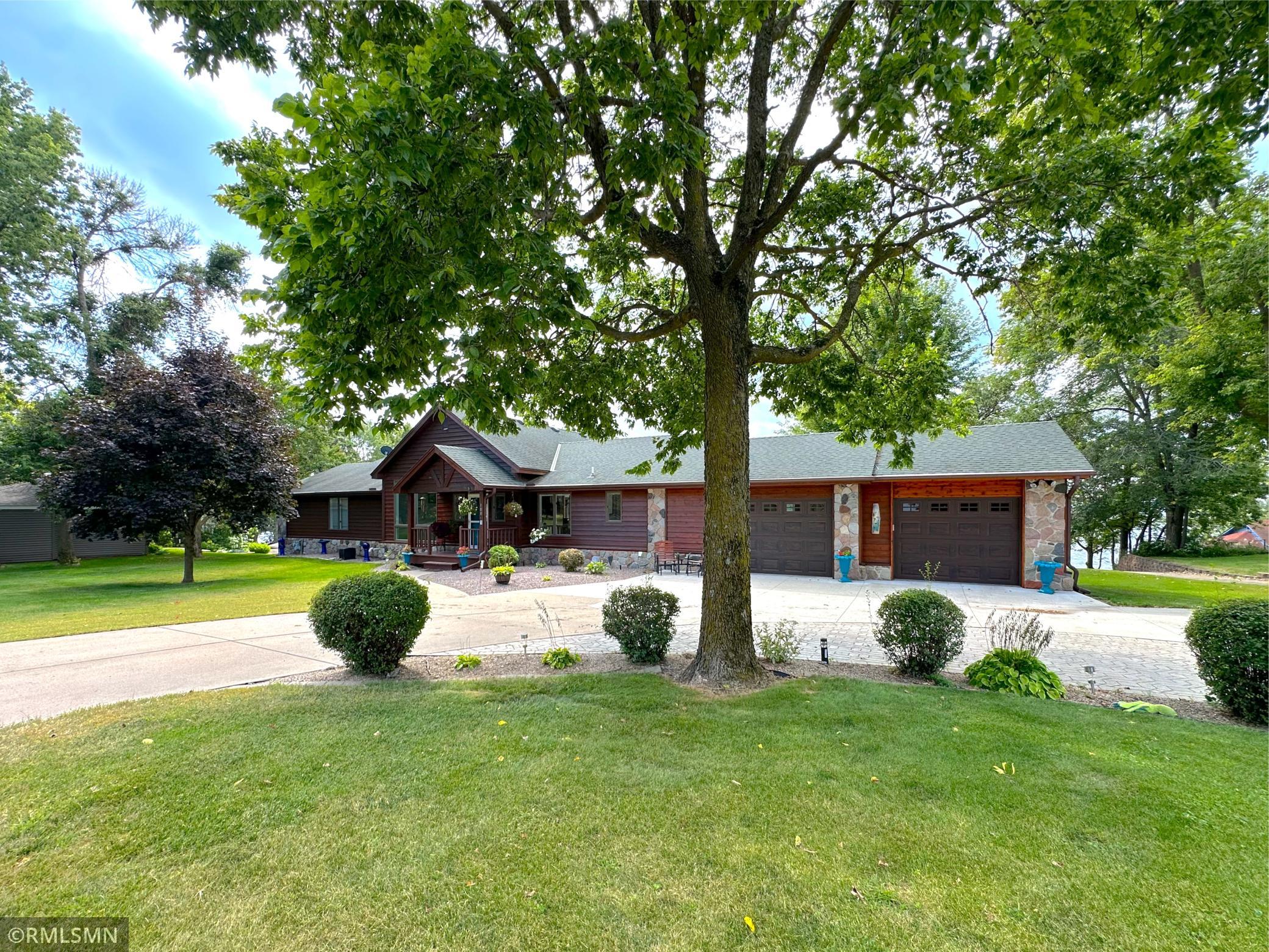 Experience lakeside living at its finest spanning over 6 acres of level land framed by mature gardens and towering trees.