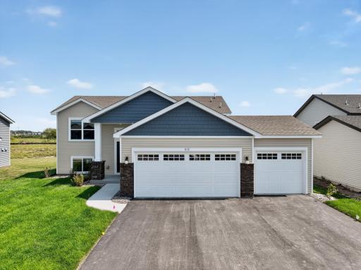 Photo is of the actual home. A stunning display from the street, introducing our Baxter plan. This home comes complete with irrigation, landscaping, trees and a full yard of sod!