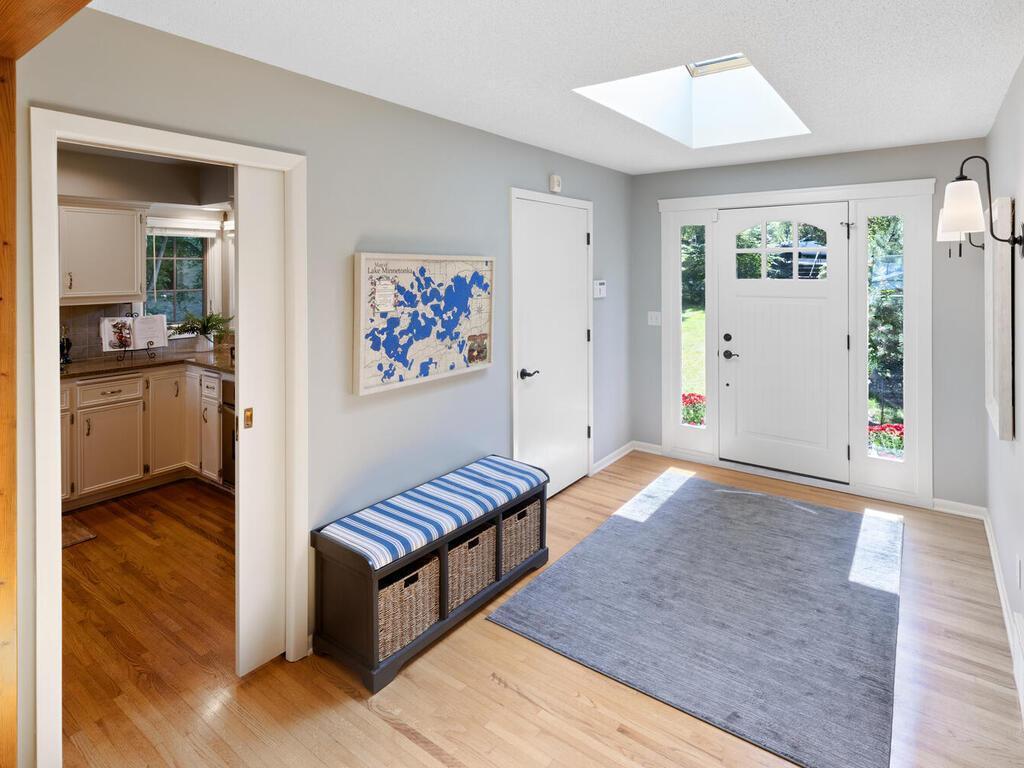 Spacious entry has wonderful skylight for maximum sunlight and a coat closet convenient for guests.