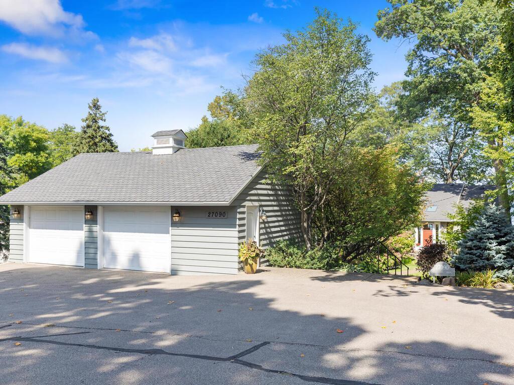 There is a spacious 2 1/2+ car garage. Roof was also replaced with architectural shingles in 11/2021. There is a huge asphalt parking area.