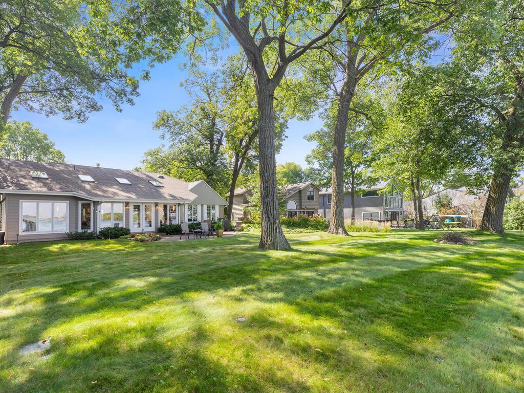 Lakeside front of home with huge yard and firepit area.