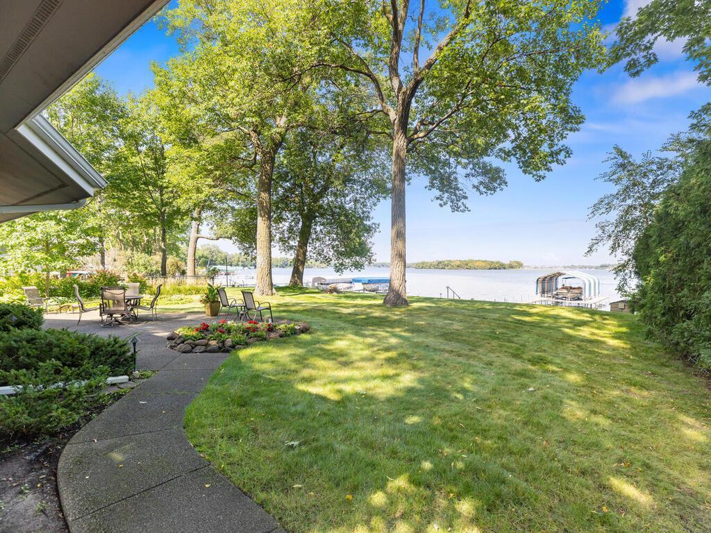 This park-like level .44 acre lot has 75' of sandy lakefront and crystal-clear water and enjoys some of the best panoramic views on the lake!
