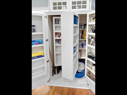 Interior of pantry that pulls out several times with loads of storage!!