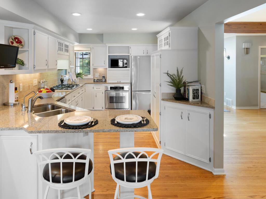 There is a double stainless steel sink, Bosch dishwasher and additional built-in corner cabinet.