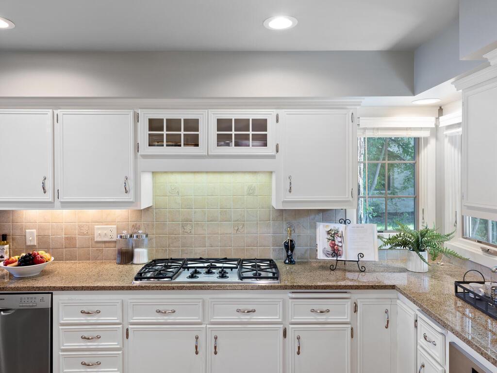 Kitchen features recessed lighting, a built-in lazy susan and several cutting boards.