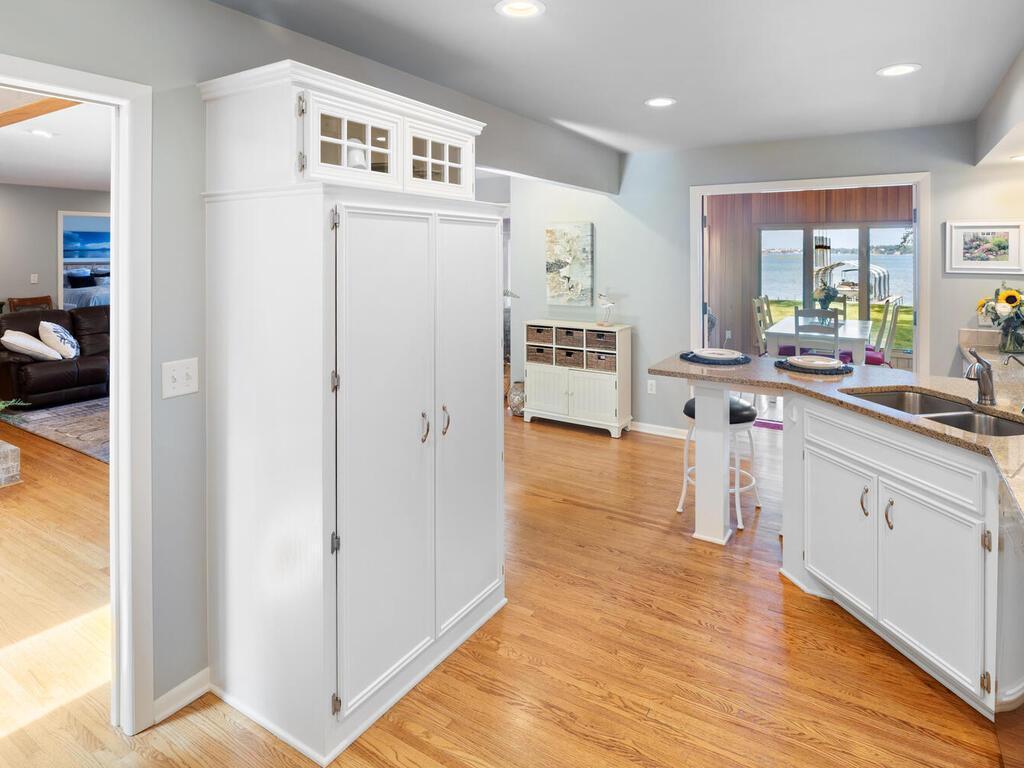 There is a huge built-in pantry with display cabinets above.