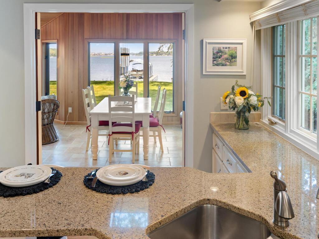 Enjoy views of lake through open glass double doors while in the Kitchen. There is a breakfast bar!