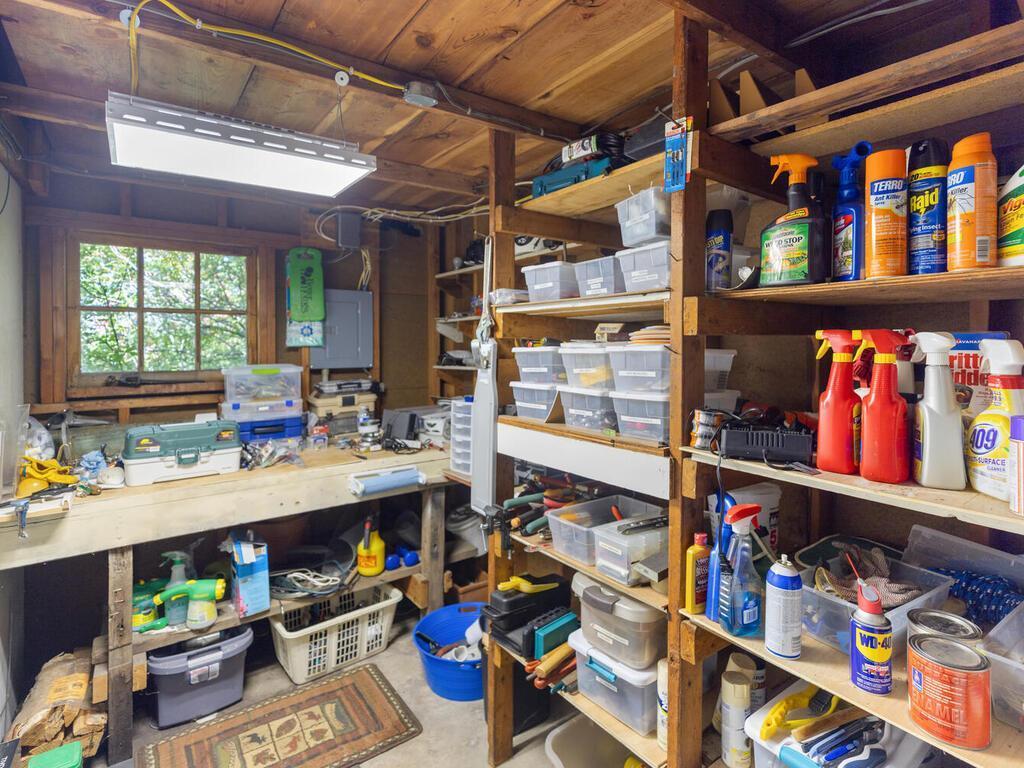 There is a spacious workroom and storage area in garage.