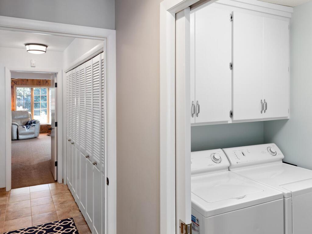 Laundry room is conveniently located in central part of home. Laundry Room has tile floor, storage cabinets plus a folding shelf