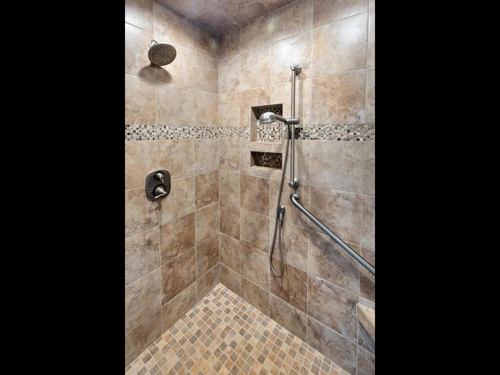 There is a spacious walk-in tiled shower.