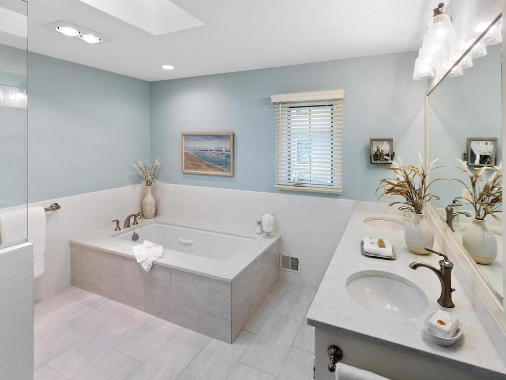 There is subway tile surround and skylight for warm brightness.