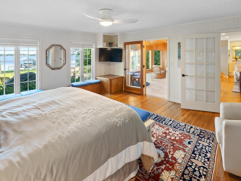 Owner's Suite has window seats with storage, glass doors that open to both Great Room and Living Room with privacy blinds.