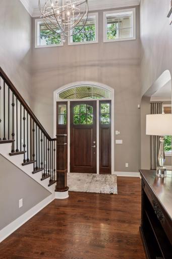 Bright and large welcoming foyer with a gorgeous chandelier.