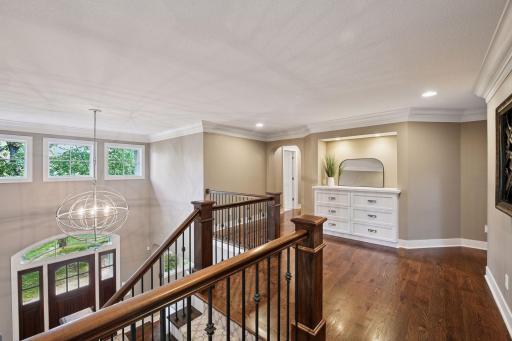 White oak hardwood flooring carries up the stairs to the landing and hallway. Build-in dresser for linens.