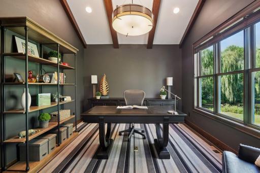 Impressive home office with faulted wood beam ceiling and a beautiful view out to the back yard and pond.