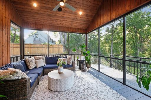 Screened in porch with knotty cedar walls and ceiling and a gas and electrical rough-in for future fireplace and TV.