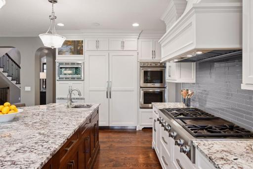 Custom cabinetry with soft close drawers and built-ins for TV, microwave and appliance garage.