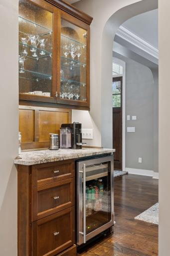 Butlers pantry with beverage refrigerator and glass door cabinets. Great for a coffee bar.