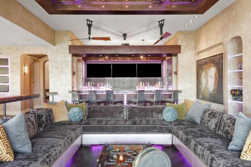 Just steps away, the custom bar rail gleams with a wink, inviting late-nite tales and cheeky midnight snacks.