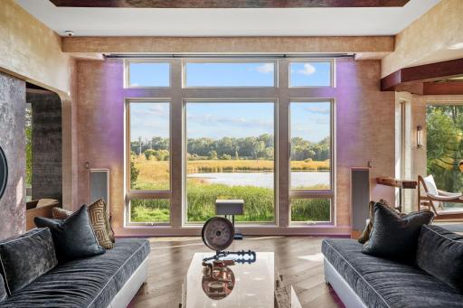 Floor-to-ceiling panes serve less as glass and more as crystal gates, dissolving the boundary between indoors and the living canvas beyond.