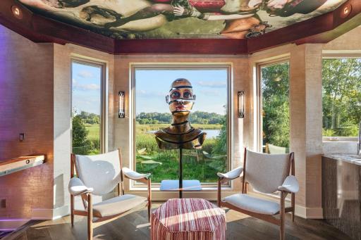 An unraveling bust lends you eyes to gaze into private wetlands, as inset lighting shimmers along the custom ceilings above.