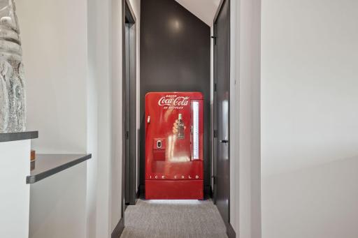 Behind sneaky Coca-Cola refrigerator doors lies an enchanted attic retreat.