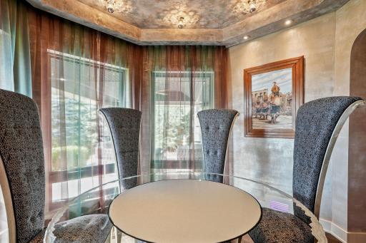 A circular arenaâlike gathering inside a portalâglows with blown glass lighting and a table etched with custom artistry.
